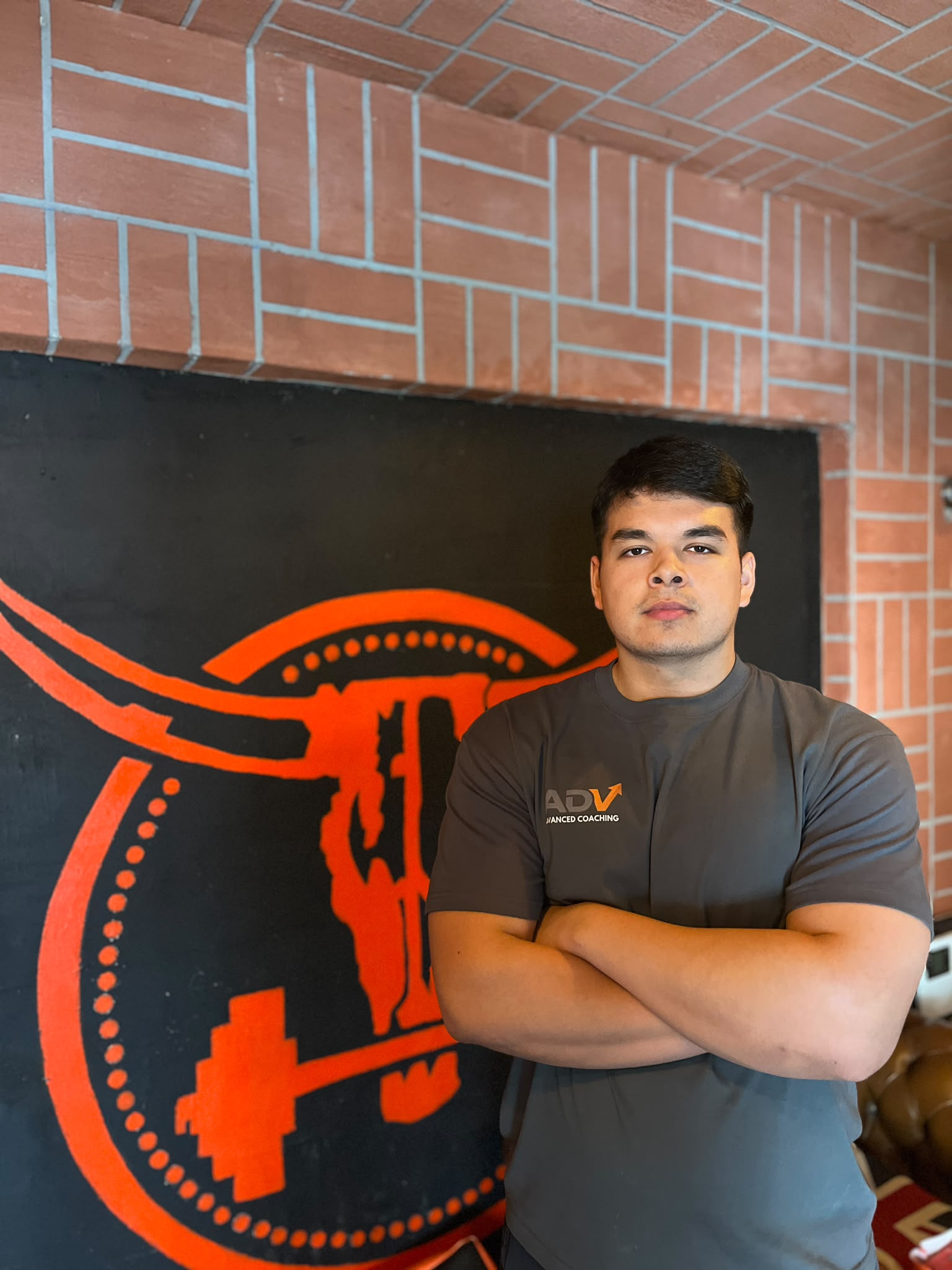 Myles, founder of Advanced Coaching, standing in the gym